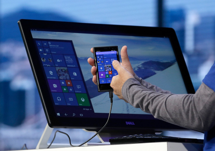Joe Belfiore, Microsoft Corporate Vice President of Operating Systems Group, demonstrates Continuum for phones at the Microsoft Build conference in San Francisco, Wednesday, April 29, 2015. While Microsoft has already previewed some aspects of the new Windows 10, a parade of top executives will use the conference to demonstrate more software features and app-building tools, with an emphasis on mobile devices as well as PCs. (AP Photo/Jeff Chiu)